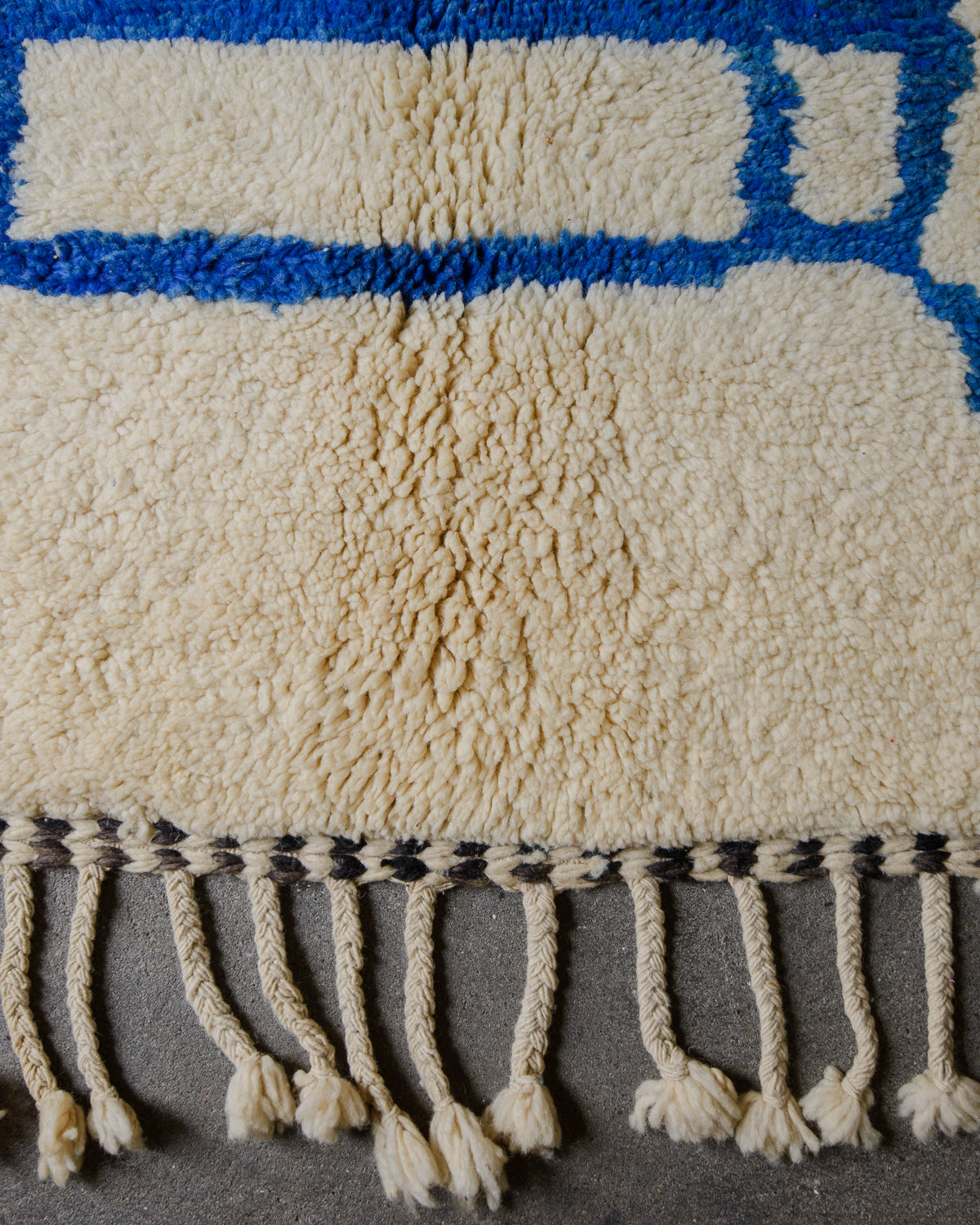 Detail of wool rug showing some discolouration.